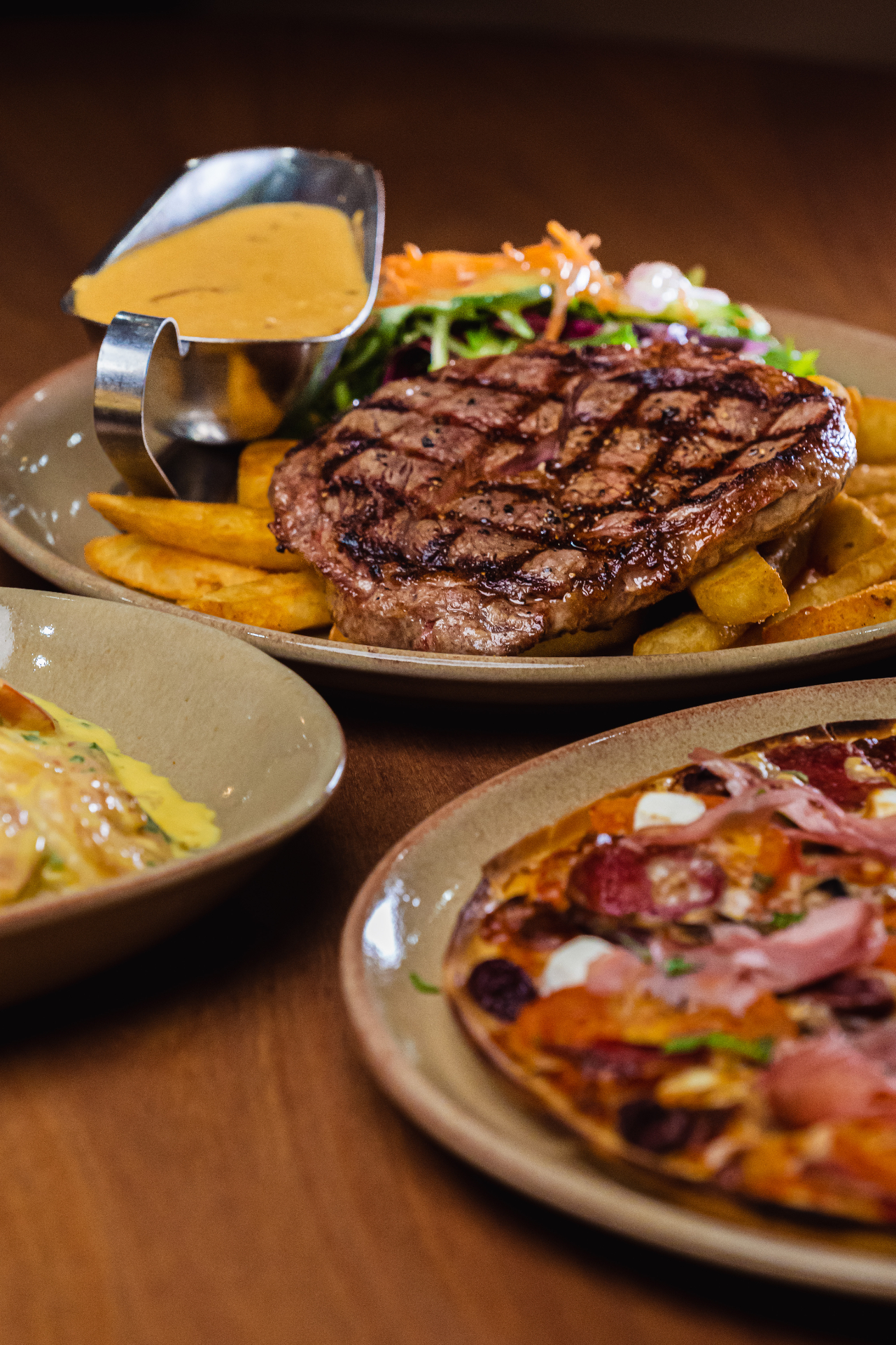 Grilled steak with chips, salad and sauce