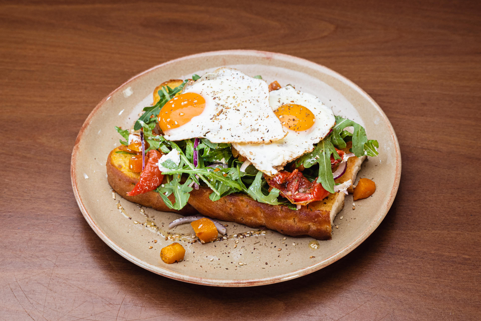 Bruschetta topped with rocket, tomato and fried eggs