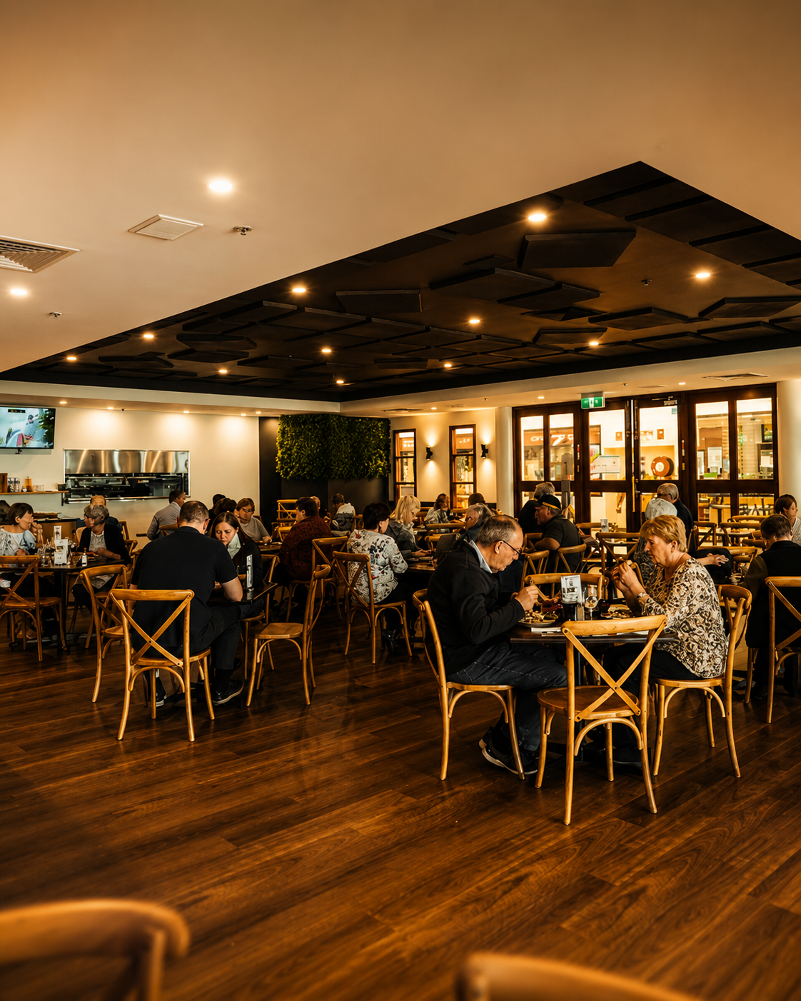 Warmly lit dining room at Caffè Buongiorno with guests at timber tables