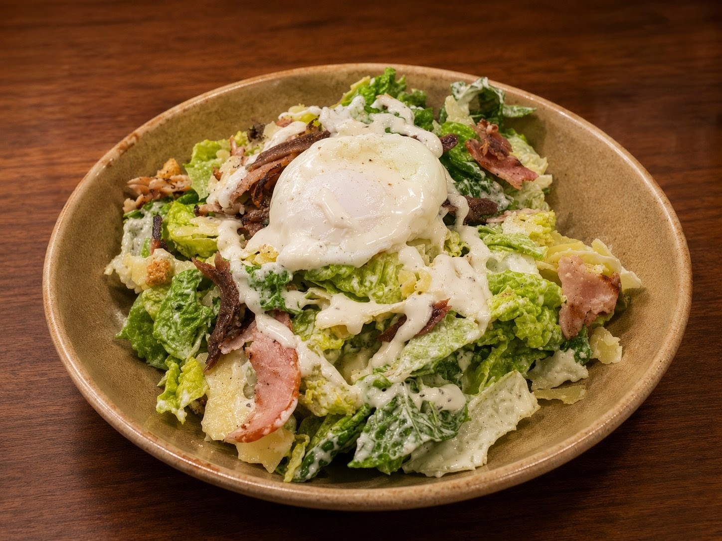 Caesar salad with soft poached egg, bacon and anchovies